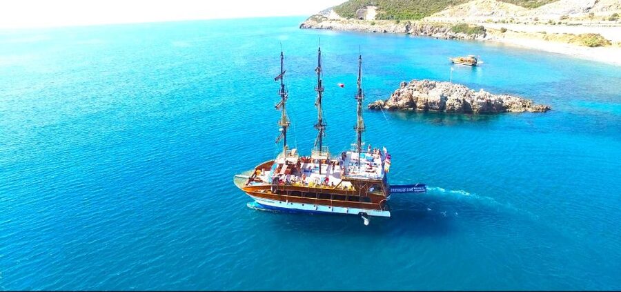 Alanya: Catamaran Boat Trip with Sunbathing and Swimming - Leaving Alanya Harbour beside the Red Tower