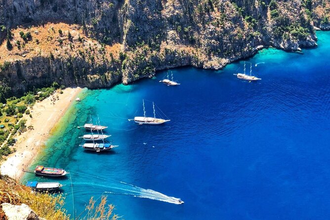 Ölüdeniz: Butterfly Valley Boat Trip with Buffet Lunch - Butterfly Valley: cliffs, beach, and a seasonal warning